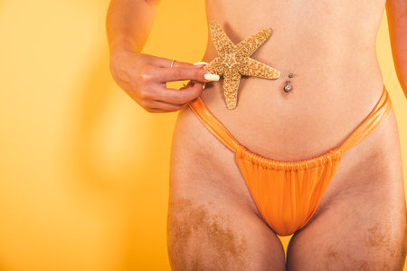 Woman ready to the summertime holds a starfish in handの写真素材