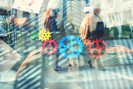 Business team connecting gears. Teamwork, partnership and integration concept. Double exposureの写真素材