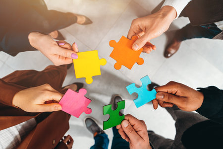 Teamwork of partners connect puzzle pieces as integration and startupの写真素材