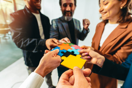 Teamwork of partners connect puzzle pieces as integration and startupの写真素材