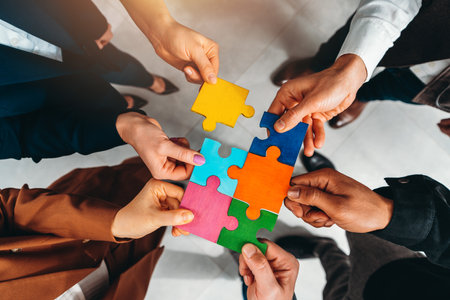 Teamwork of partners connect puzzle pieces as integration and startupの写真素材