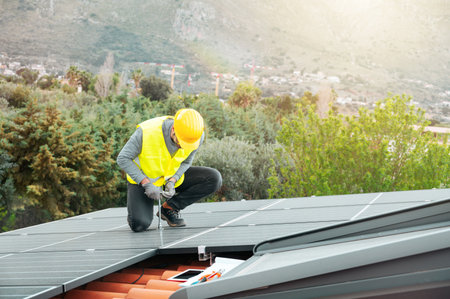 Workers assemble energy system with solar panel for electricityの写真素材
