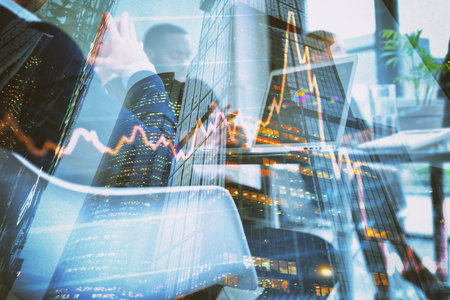 Double exposure of businessmen and skyscrapers with the stock market graphics