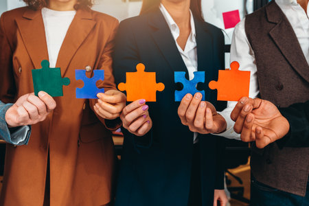 Teamwork of partners connect puzzle pieces as integration and startupの写真素材