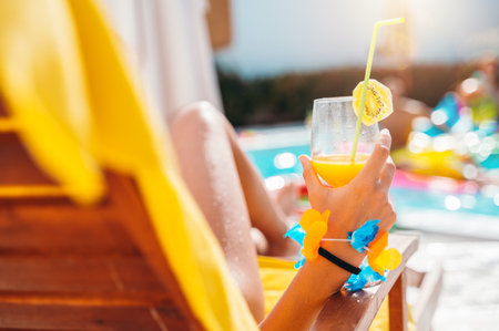 Group of friends in swimsuit drink a cocktail in a swimming poolの写真素材