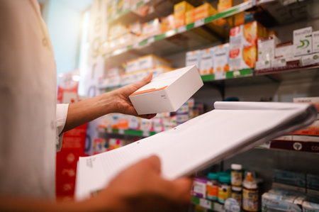 Woman working in the pharmacy looks for the medicineの写真素材