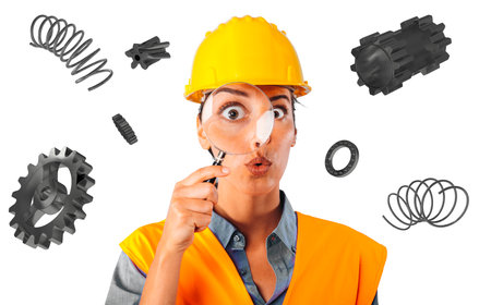 Amazed woman worker with helmet and magnifier