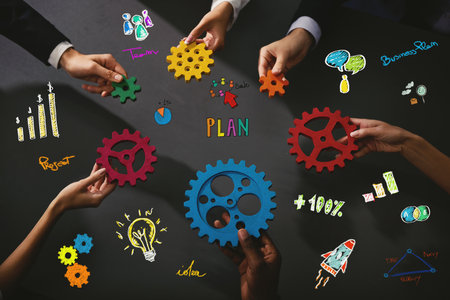 Business team work together and combine pieces of gears. Partnership and integration conceptの写真素材
