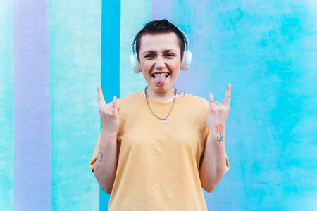 Happy woman listens to music with white headphones