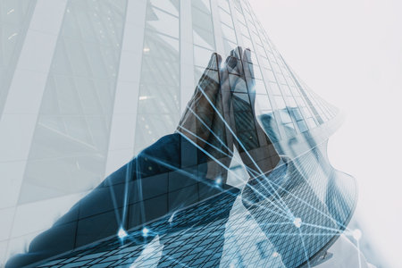 Handshaking between businessmen. Double exposure with modern officeの写真素材