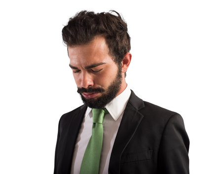 Tired businessman is exhausted due to overworkedの写真素材