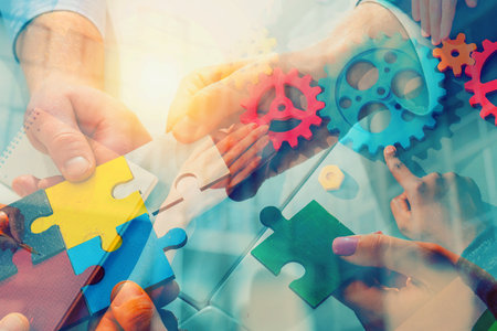 Team working background with puzzles and gears. double exposure effectsの写真素材