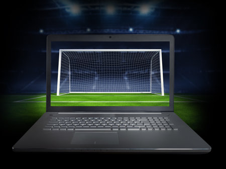 Live streaming of a soccer player match on a laptopの写真素材
