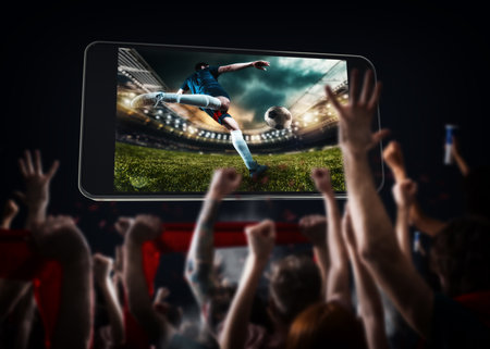 Watch a live sports event on your mobile device. Betting on football matchesの写真素材
