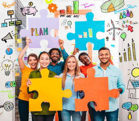 Teamwork of partners that work with puzzle on a new creative business projectの写真素材