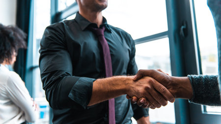 Handshaking of business people in office as concept of teamwork and partnership