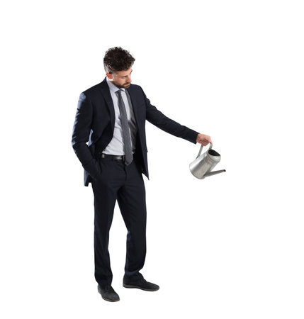 Confident businessman with watering can in handの写真素材