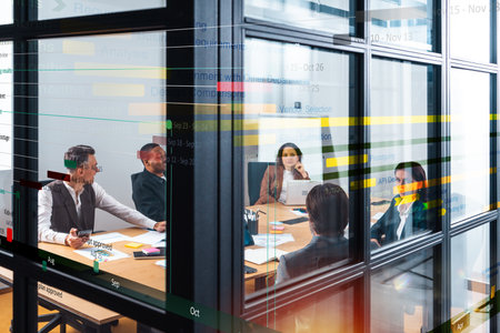 Team of people work together on company statistics in office as teamwork and partnership conceptの写真素材