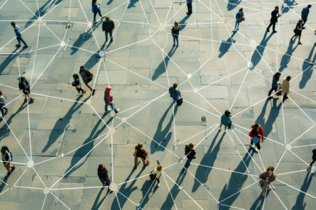 Aerial view of people walking on a large square with connections between themの素材
