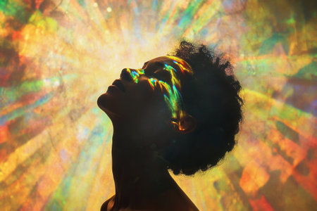 Woman feeling the light projected on her face, exploring spirituality and psychedelic visionsの素材