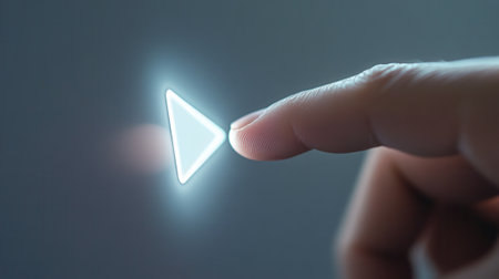 Finger touching glowing play button starting video playbackの素材