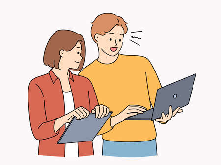 Smiling colleagues cooperate on laptop