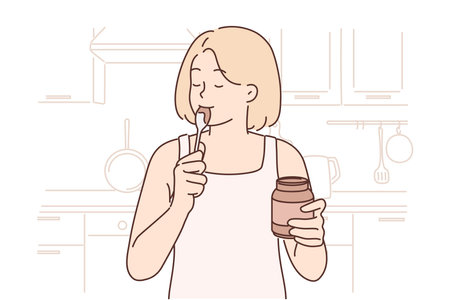 Happy woman stands in kitchen with jar of chocolate paste or peanut butter and licks spoonのイラスト素材