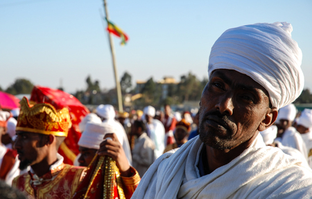Addis Ababa, 18th January 2007: Priest in white robes resting during Epiphany celebrations