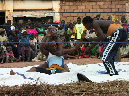 Pweto, Katanga, DRC, 20th May 2006: Wrestlers staging a fight in front of crowdのeditorial素材