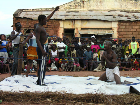 Pweto, Katanga, DRC, 20th May 2006: Wrestling match: Referee punishing wrestler in front of crowdのeditorial素材