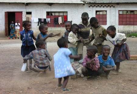 Lubumbashi, Democratic Republic of Congo, circa May 2006: Group of children playing in the yard of an old factory. In the  industrial quarter of the city there are several former factories where now people live and workのeditorial素材
