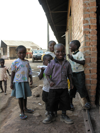 Lubumbashi, Democratic Republic of Congo, circa May 2006: Group of children posing in the yard of an old factory. In the  industrial quarter of the city there are several former factories where now people live and workのeditorial素材