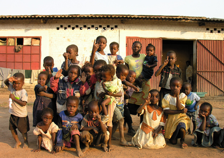 Lubumbashi, Democratic Republic of Congo, circa May 2006: Group of children and women posing for the camera in the yard of an abandoned factory. In the  industrial quarter of the city there are several former factories now reutilized as improvised living のeditorial素材