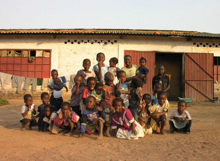 Lubumbashi, Democratic Republic of Congo, circa May 2006: Group of children posing for the camera in the yard of an abandoned factory. In the  industrial quarter of the city there are several former factories now reutilized as improvised living quartersのeditorial素材
