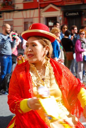 Madrid, Spain, March 2nd 2019: Carnival parade, woman from Bolivian dance team dancing with typical costumeのeditorial素材