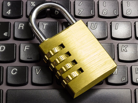 Closed or locked combination padlock on a laptop keyboard symbolizing data, computer and business...
