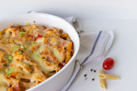 Gratin with pasta and cheese in white casserole.の写真素材