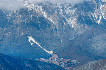 Aerial view of the city bellow the big mountain slope.