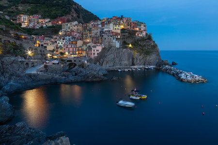 Manarola village on cliff and sea at sunset., Cinque Terre National Park, Liguria Italy.