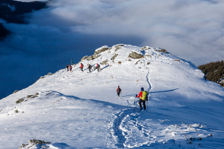Hikers in the mountains on a ridge high above cloud banks in the valleys bellow, Carpathiansの写真素材