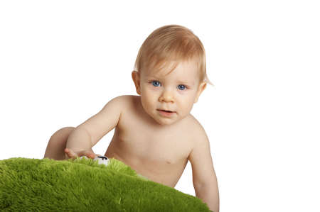 baby with a green pillowの写真素材