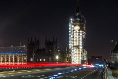 Big ben at night, at this time the tower was under construction. There are also light trails from cars.の写真素材