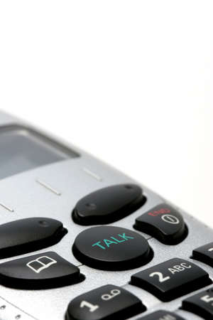 macro of a cordless phone handset over white, with focus on the