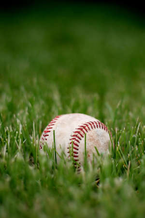 game over, retired baseball in the grassの写真素材