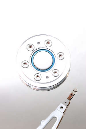 macro of a hard drive motor and read/write head, processed in highkey