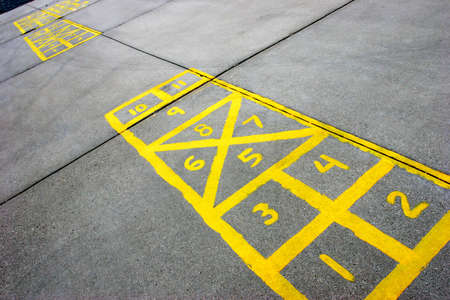 yellow hopscotch boards at a schoolyardの写真素材