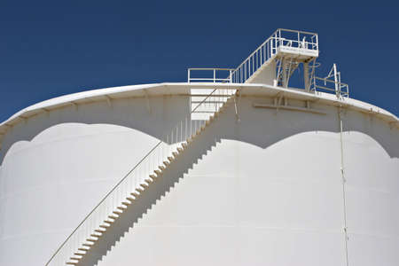 oil storage tank against blue skyの写真素材
