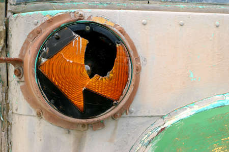 the broken blinker of an old and abandoned small busの写真素材