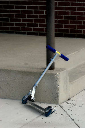 a kid's scooter parked at schoolの写真素材