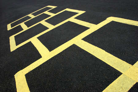 hopscotch jumping game at a school, yellow on blackの写真素材